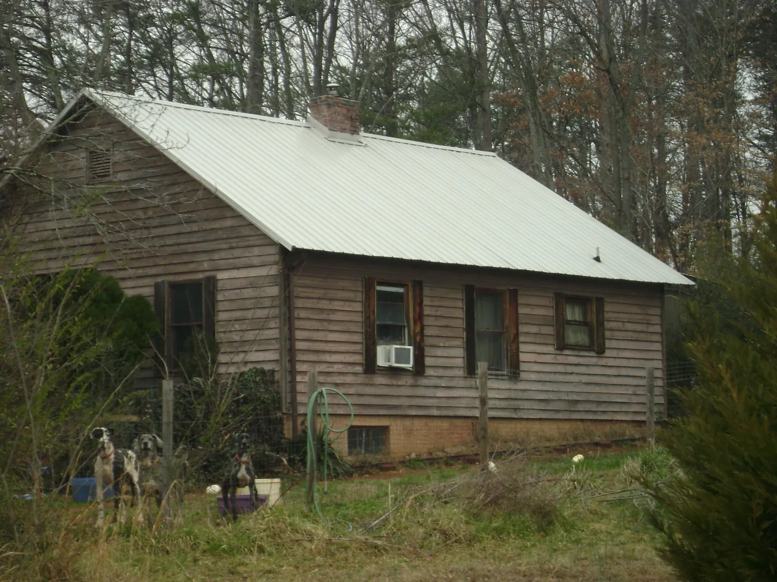 White metal roof on an old wood sided farmhouse, from a Metal Roof Installation job in Shady Cove