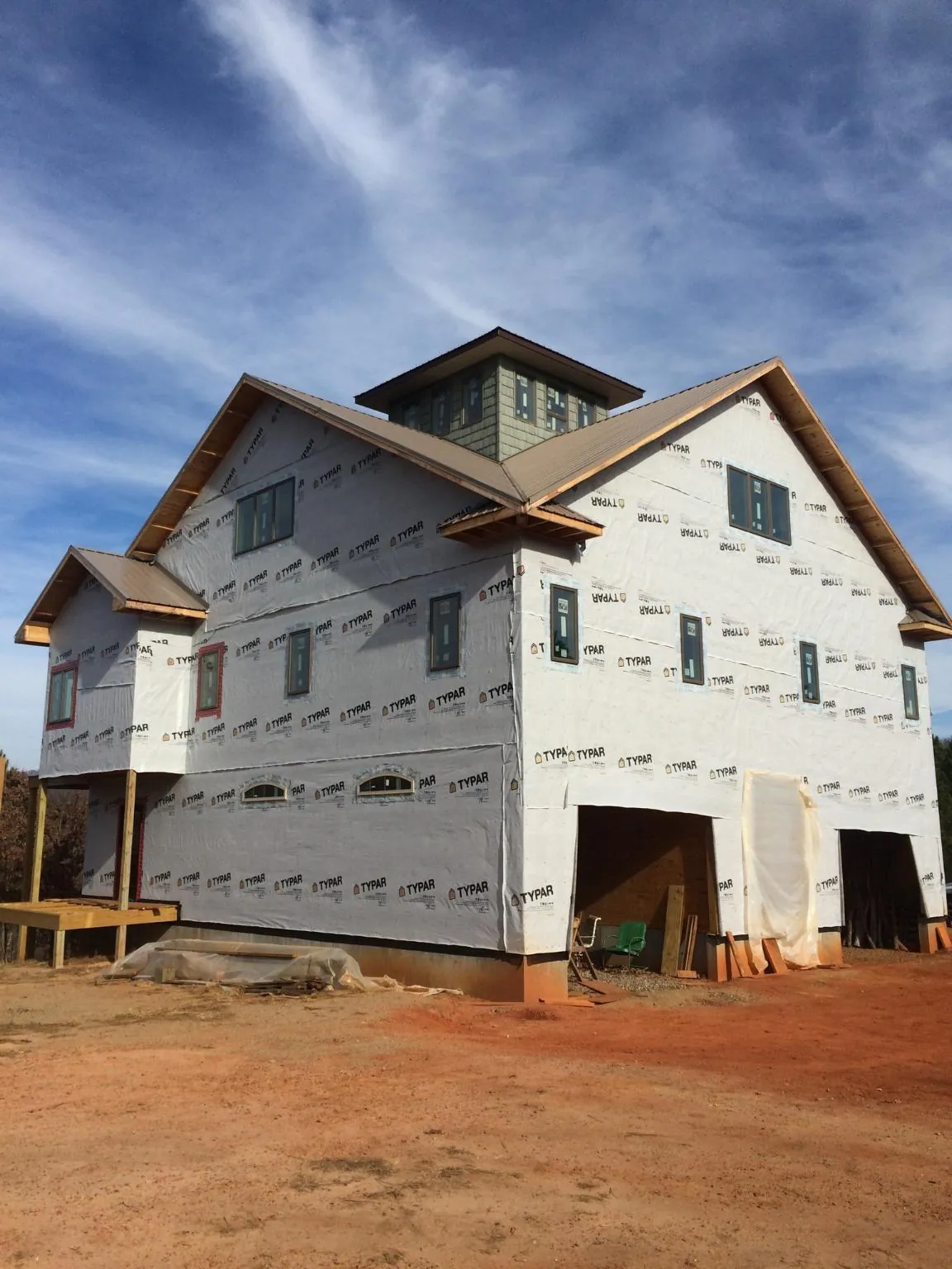 New two story house under construction with a cupola and gabled roofs in Shady Cove